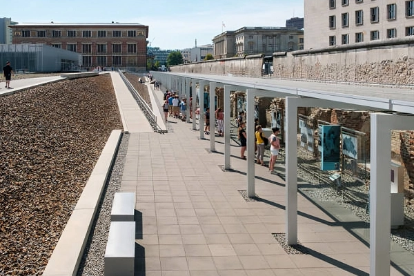 Outdoor exhibition at the Topography of Terror museum in Berlin featuring the original Berlin Wall and historical displays.