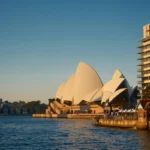 Sydney Opera House viewed across Sydney Harbour in warm evening light