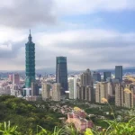 Taipei skyline with Taipei 101 tower and lush green hills in the foreground, Taiwan