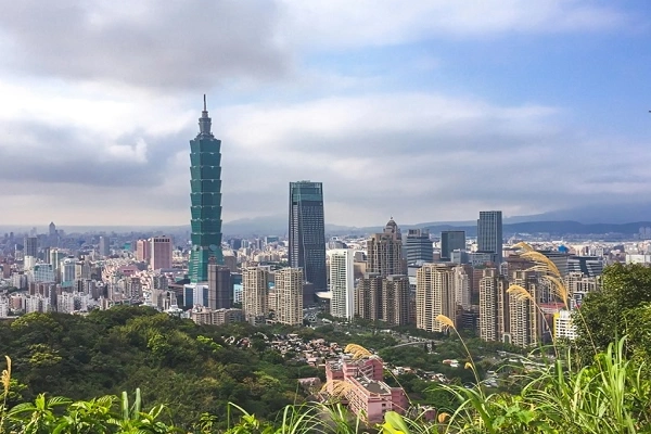 Taipei skyline with Taipei 101 tower and lush green hills in the foreground, Taiwan