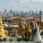 Bangkok Grand Palace and Wat Phra Kaew with the modern Bangkok skyline in the background, Thailand