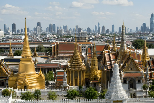 Bangkok Grand Palace and Wat Phra Kaew with the modern Bangkok skyline in the background, Thailand