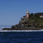 Macquarie Lighthouse standing on rocky coastal cliffs in Sydney, one of the city's historic hidden landmarks