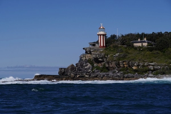 Macquarie Lighthouse standing on rocky coastal cliffs in Sydney, one of the city's historic hidden landmarks